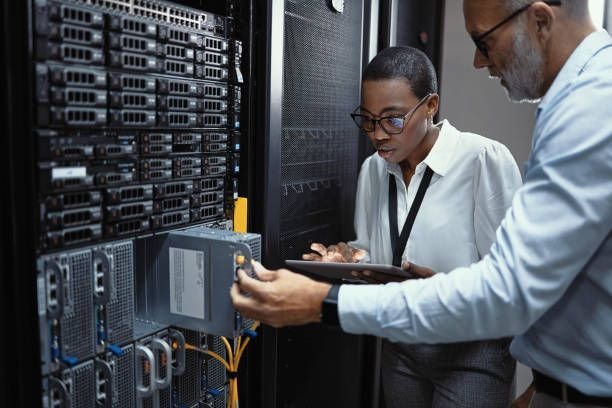 IT professionals diagnosing server hardware in a data center for business continuity